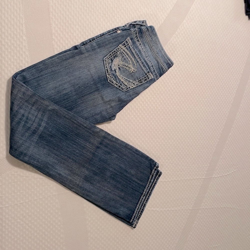 Distressed jeans with lace backing.